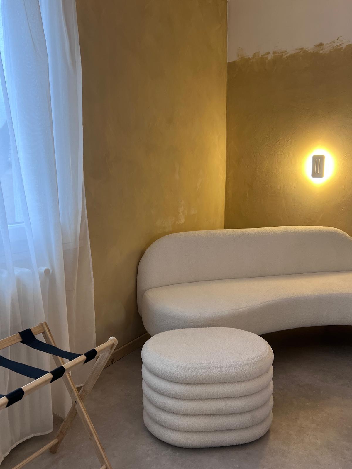 Espace de repos aux formes arrondies, lumière douce et matières naturelles chez Origines be holistic.